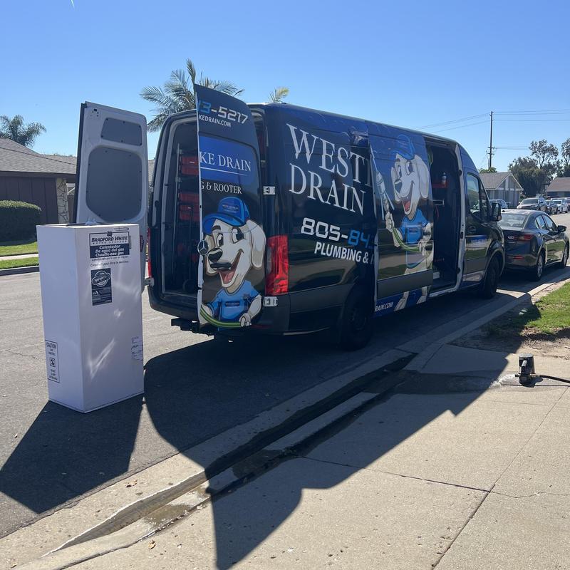 Bradford White water heater next to plumber van