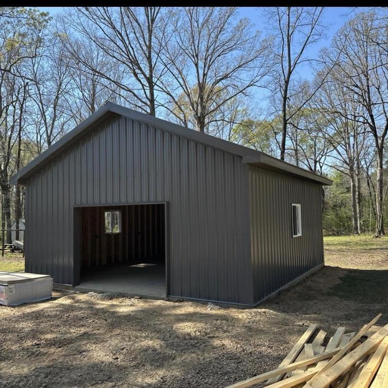 Metal building exterior with open doorway under construction