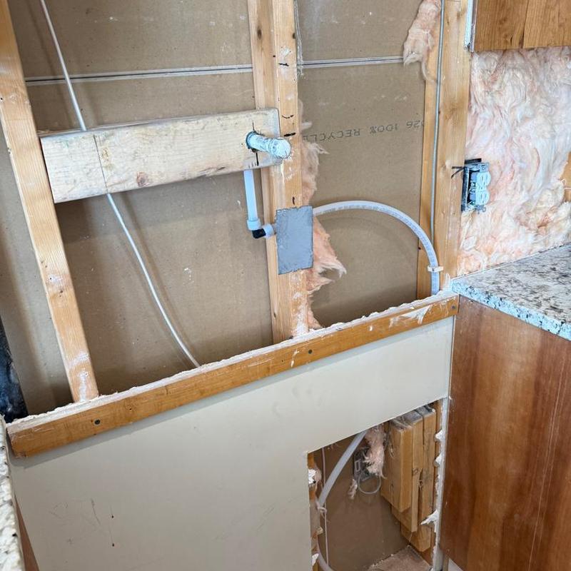 Kitchen plumbing rough-in with electrical wiring and insulation