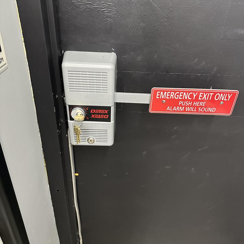 Exit alarm bar with keys on emergency door