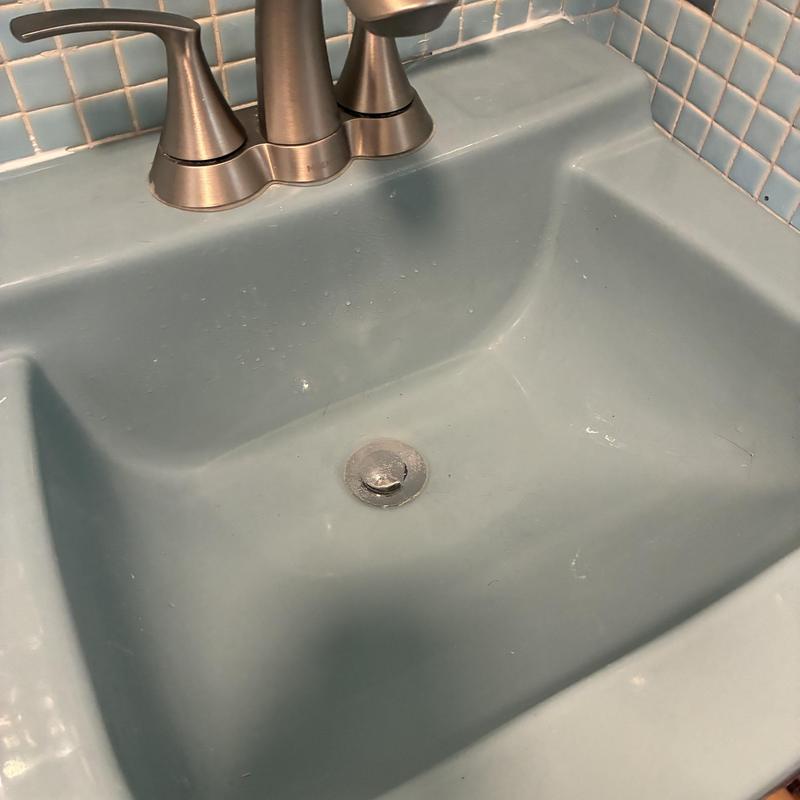 Basin drain with metal stopper and faucet handles