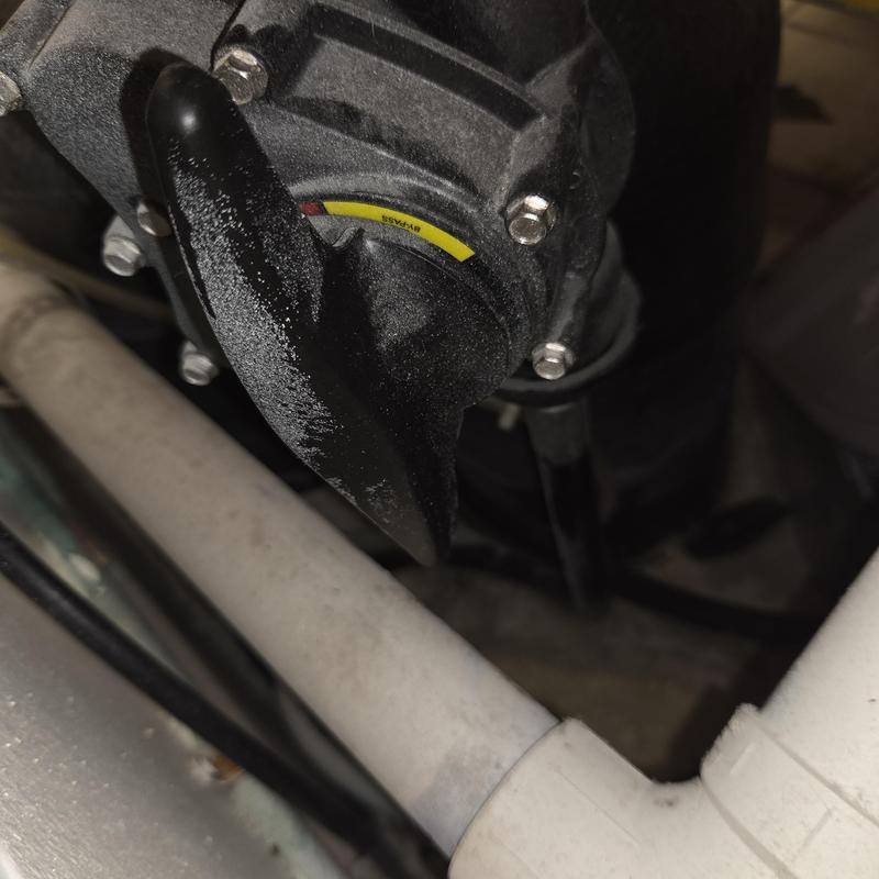 Water softener valve and plumbing connections close-up