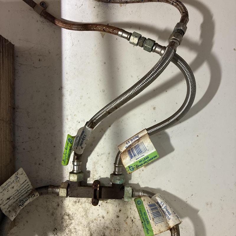 Braided stainless steel water supply lines under kitchen sink