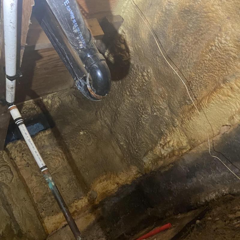 Shower drain plumbing with pipe insulation in crawlspace