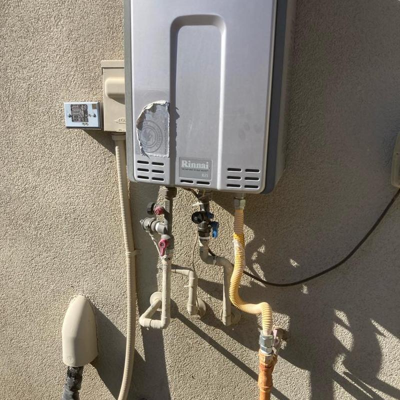 Tankless water heater exterior with connected plumbing valves