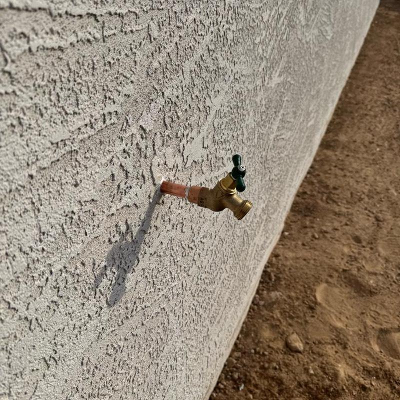 Hose bib installation on textured exterior wall
