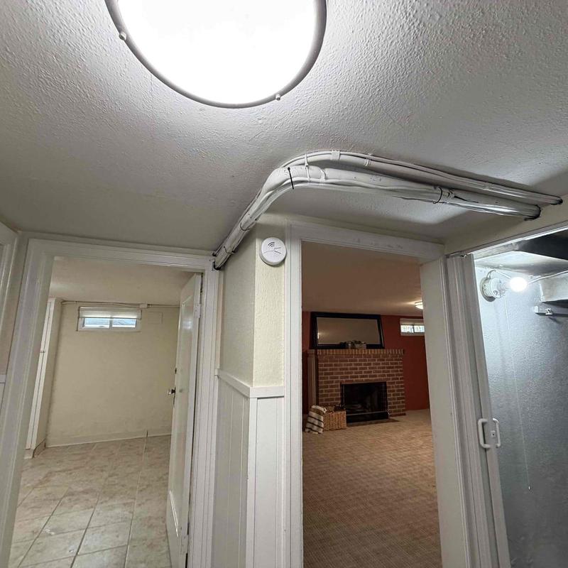 Condensation pump piping installation along ceiling corner