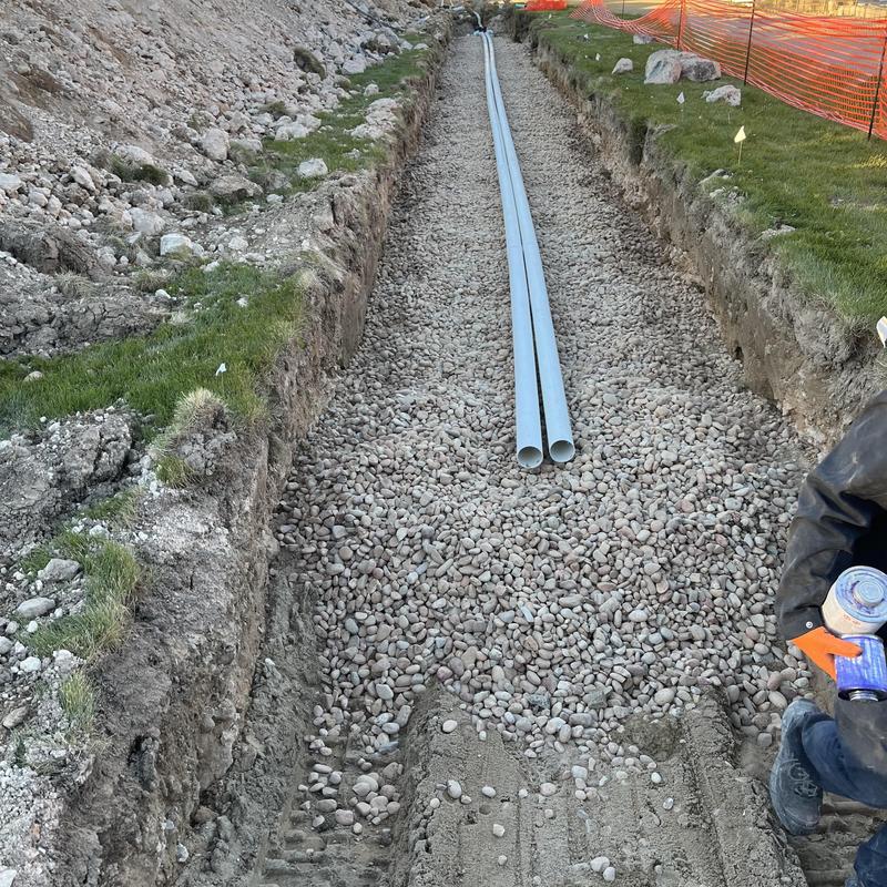 Septic system gravel bed with PVC pipes installation