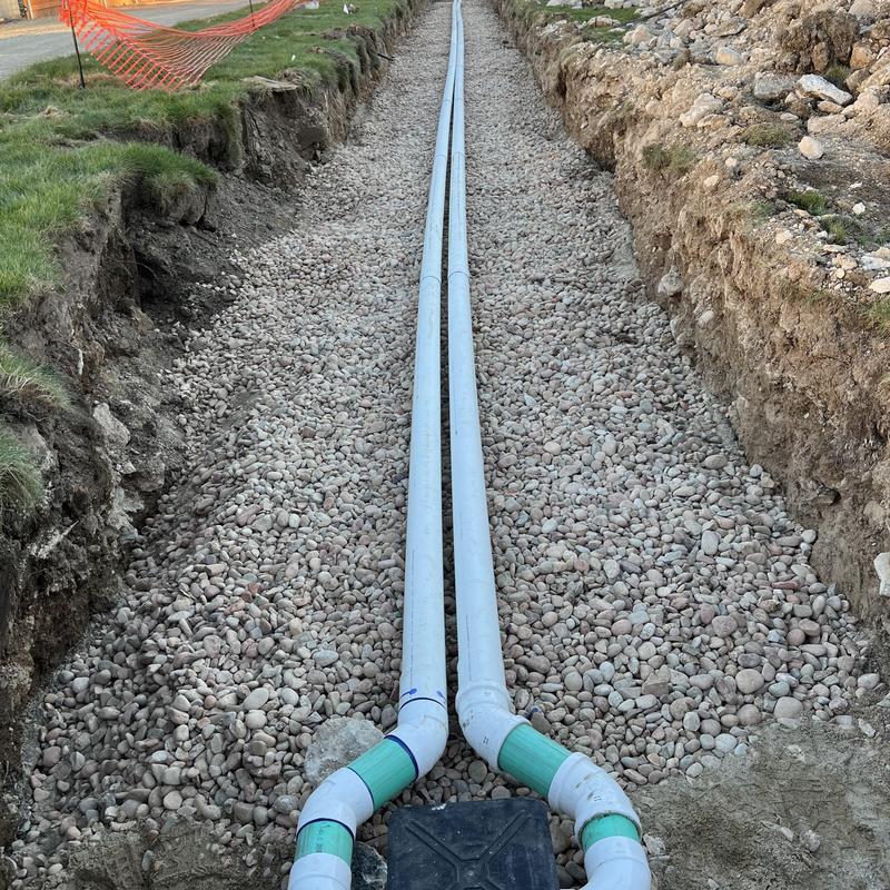 Septic system drainage pipes in trench with gravel base