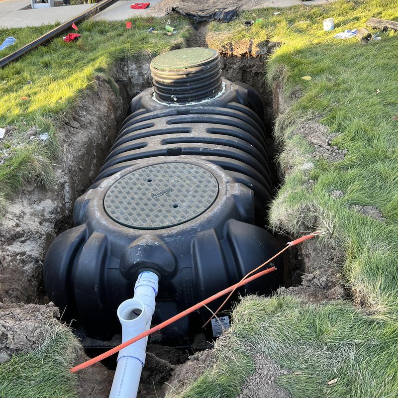 Septic tank installation in dug trench with piping