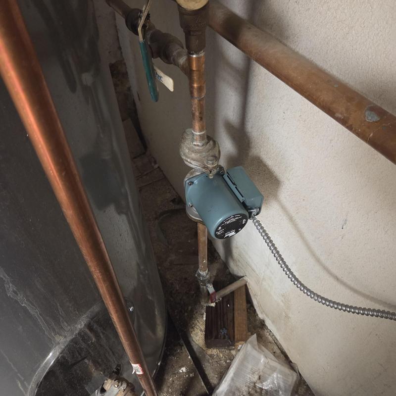 Hot water pump and copper piping near water heater