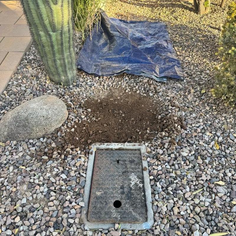 Irrigation valve box installation in rock landscaping