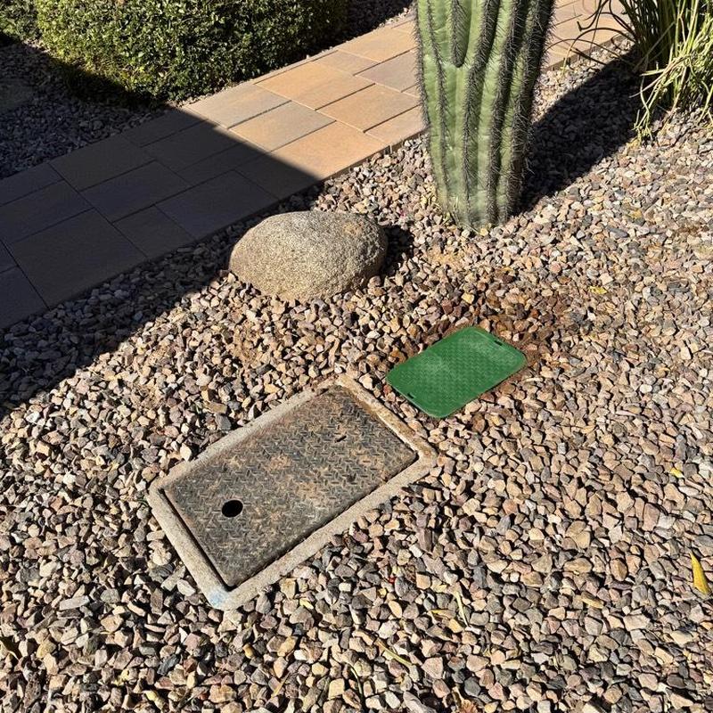 Pressure regulating valve irrigation access box in gravel