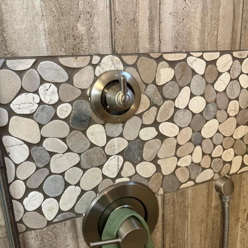 Moen diverter cartridge and shower handle on tile wall