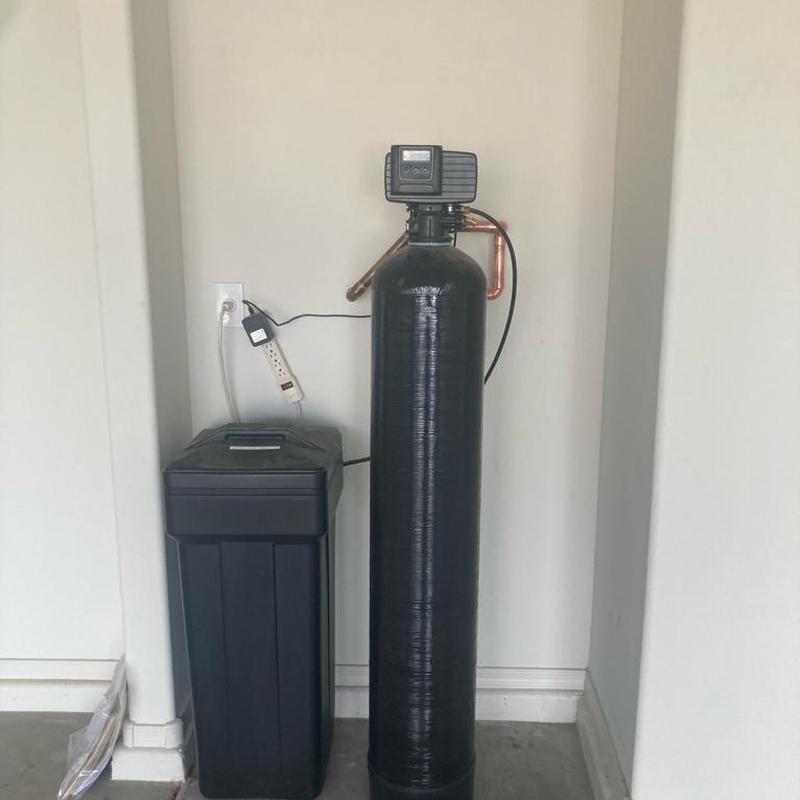 Water softener system with control valve in utility room