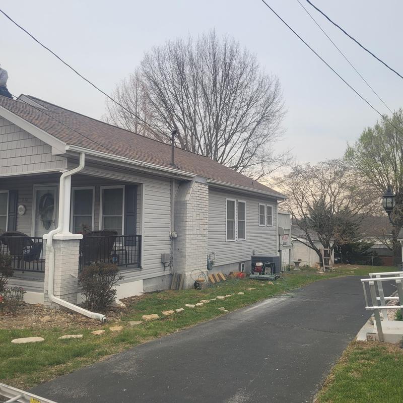 Asphalt shingle roof with chimney and fascia work