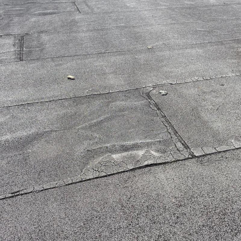 Modified bitumen roof with cracking and blistering damage