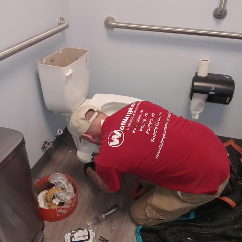 Toilet tank plumbing repair in commercial restroom Toilet tank plumbing repair in commercial restroom