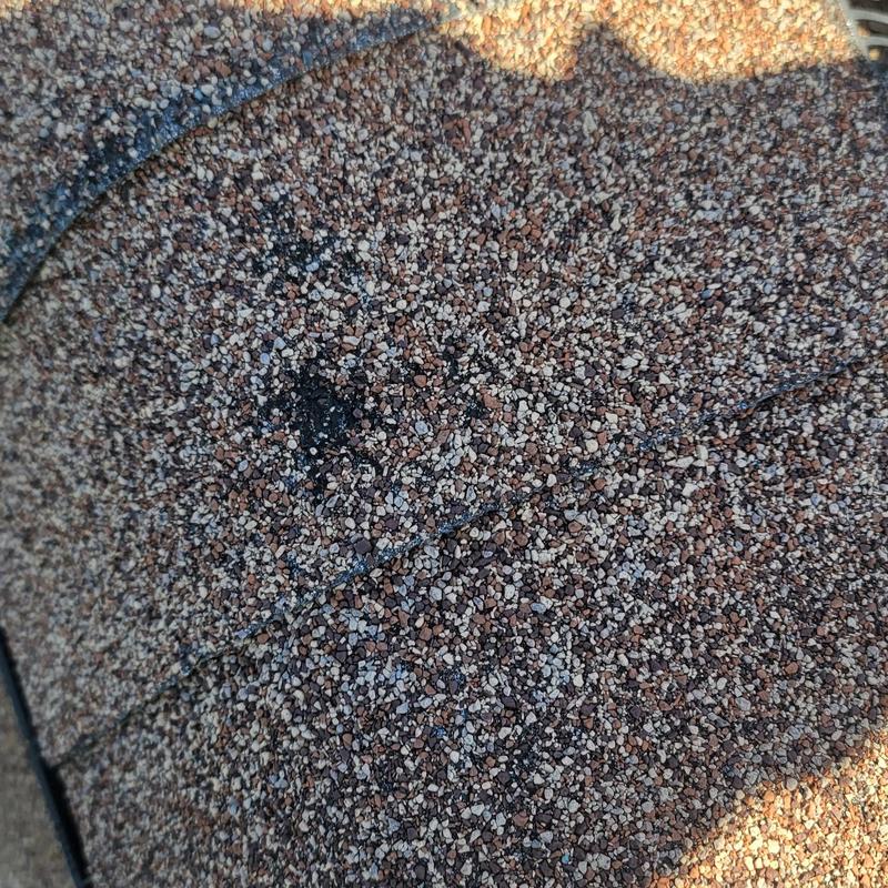 Asphalt shingle roof with hail damage close-up