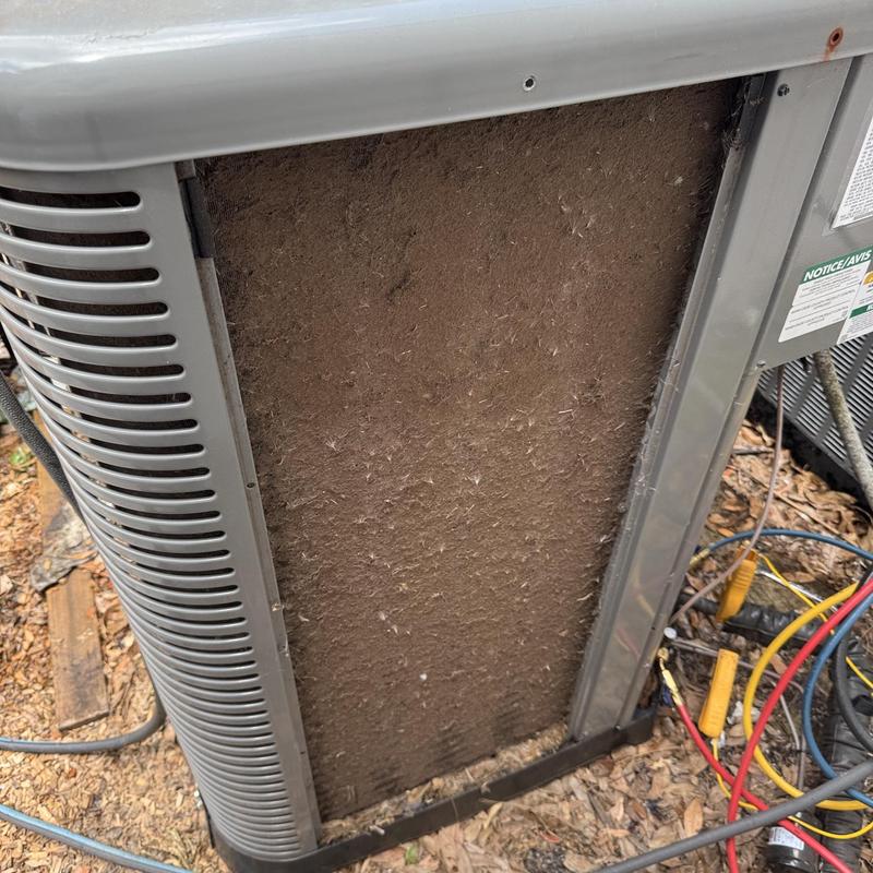 Condenser coil clogged with dirt on outdoor AC unit