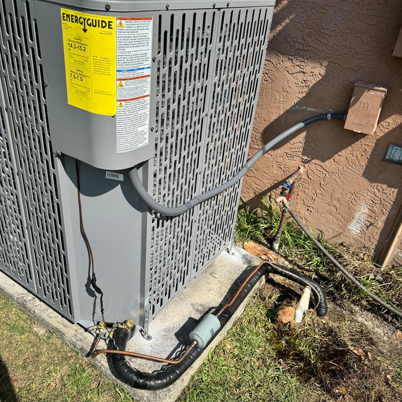 Heat pump outdoor unit with refrigerant line and wiring
