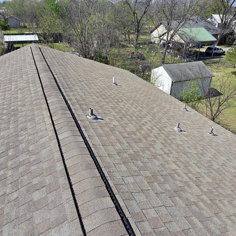 Asphalt shingle roof with pipe boots and ridge vent
