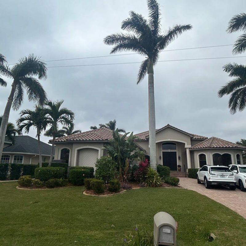 Concrete tile roof with foam adhesive and underlayment