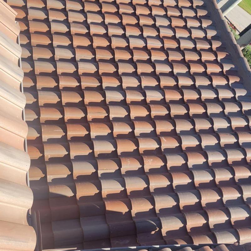 Concrete tile roof with foam adhesive and underlayment
