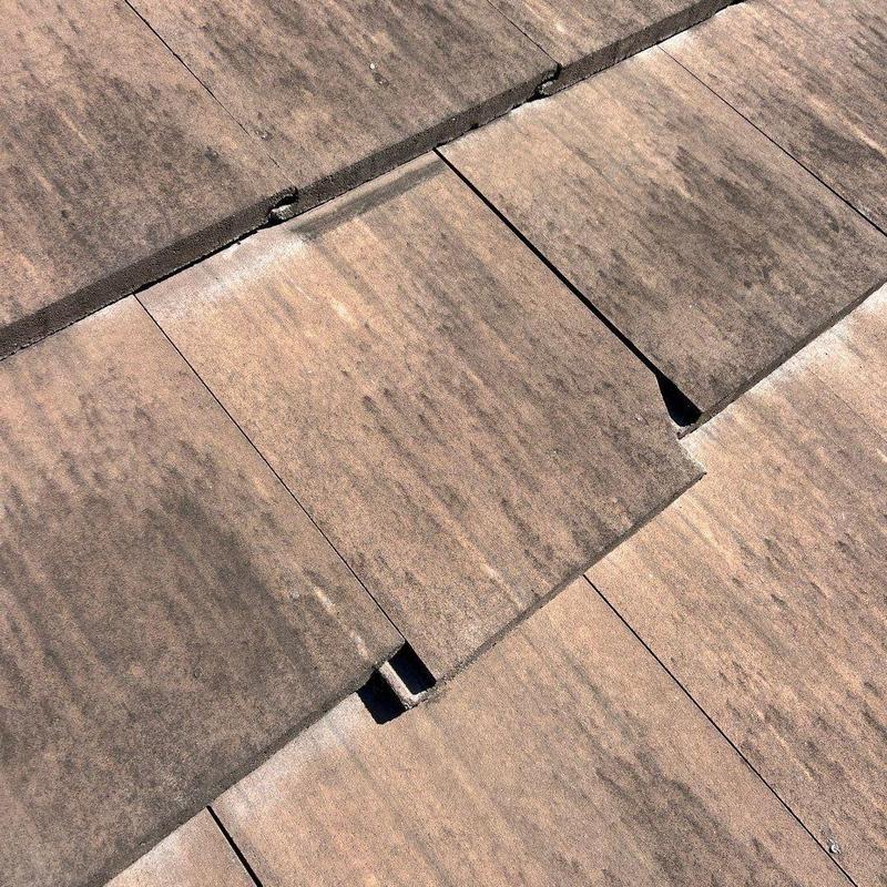 Concrete tile roof with cracked and broken sections