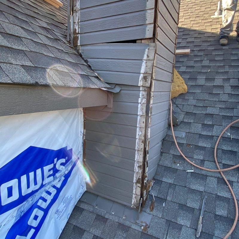Chimney siding and flashing repair on roof shingles