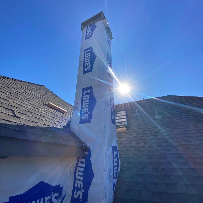 Chimney siding wrapped in Lowe's protective house wrap