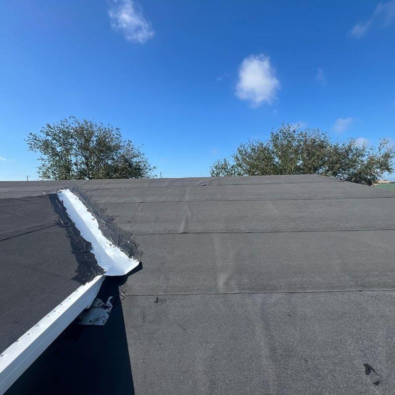 Flat roof dry-in underlayment with sealed flashing