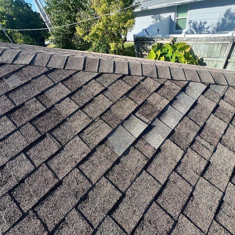 Asphalt shingles with patch repairs on a residential roof