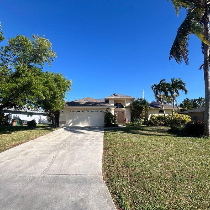Concrete driveway and shingle roof on suburban home