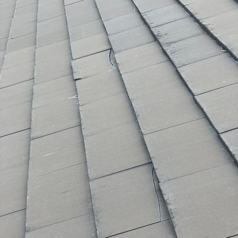 Concrete tile roof with cracked and broken tiles