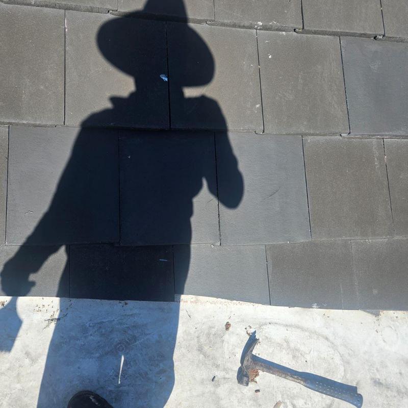 Concrete tile roof with replacement tile patch