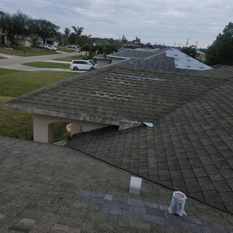 Shingle roof with worn and patched shingles in Cape Coral