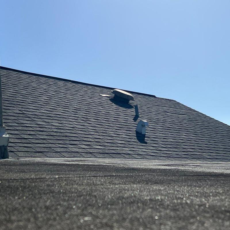 Asphalt shingle roof with worn, deteriorated shingles