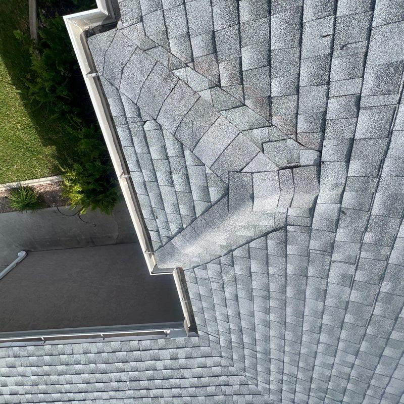 Gray shingle roof with worn and cracked shingles