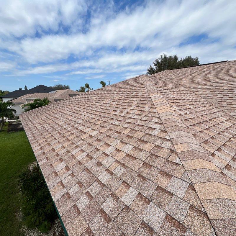 Shingle roof with new impact-resistant skylights installed