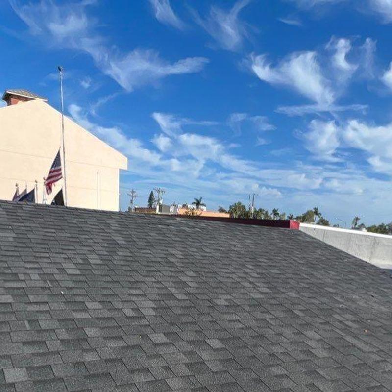 Asphalt shingle roof with clear blue sky background