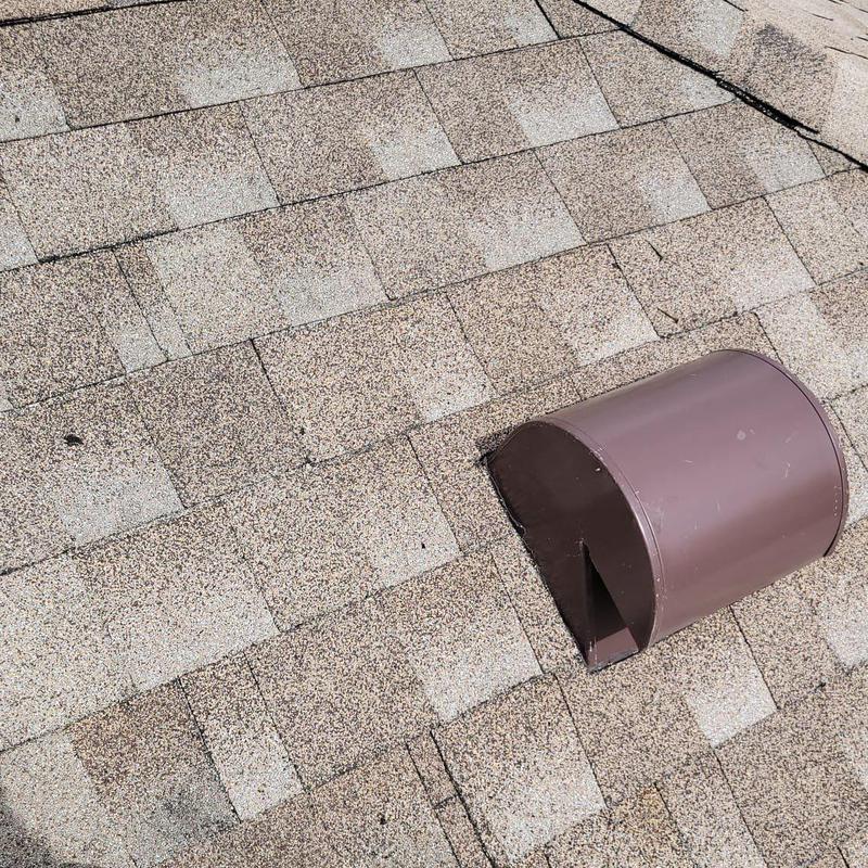 Shingle roof with brown metal vent on top