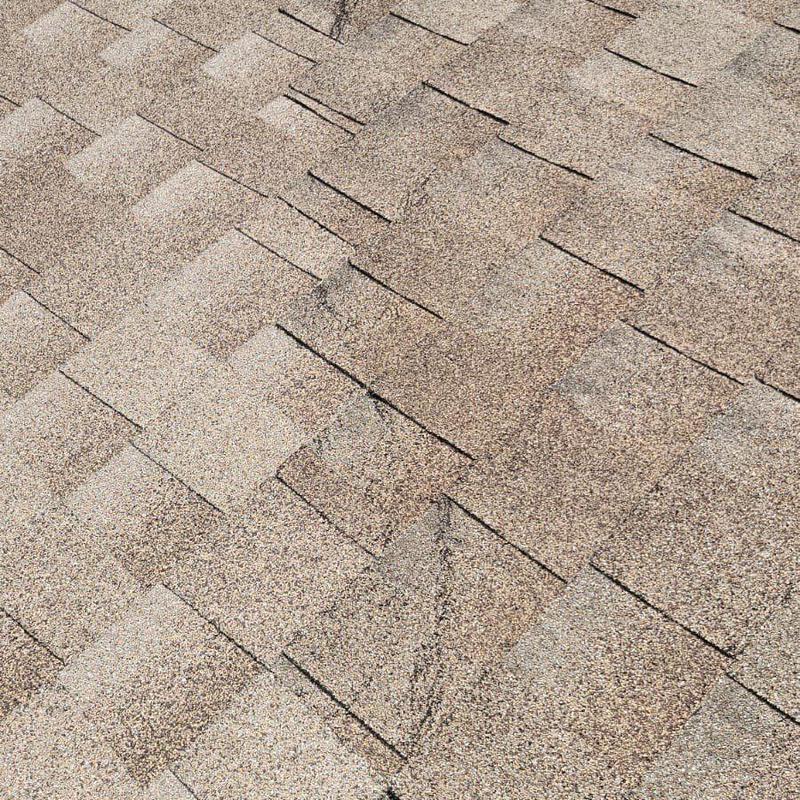 Asphalt shingle roofing with repaired damaged sections