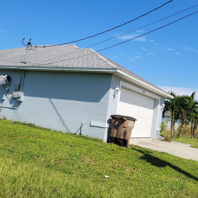 Shingle roof on residential house with garage door