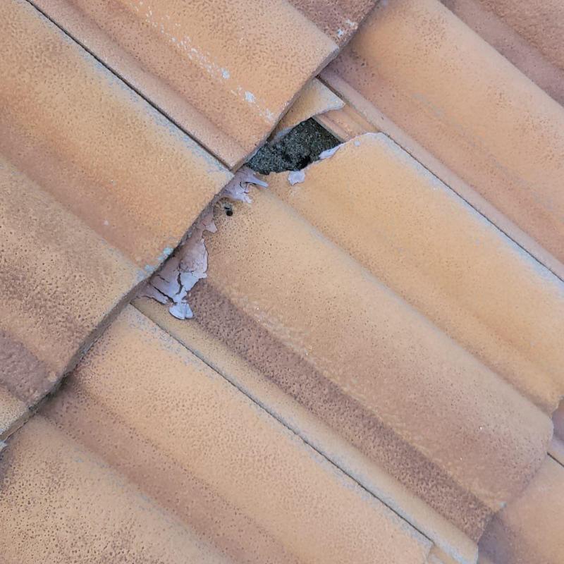Concrete tile roof with broken and cracked tiles