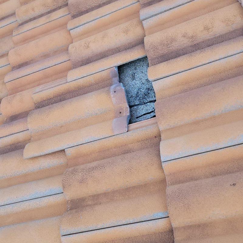 Concrete tile roof with broken tile and failure signs