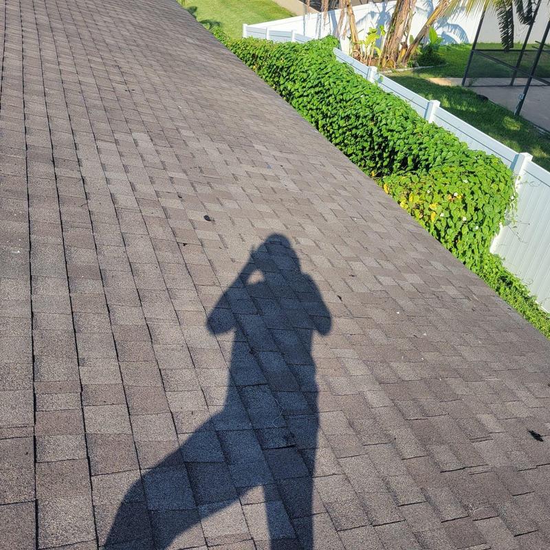 Asphalt shingle roof close-up showing repaired area