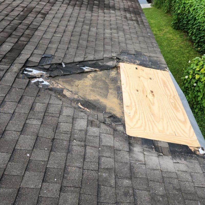 Roof valley damaged with temporary plywood patch