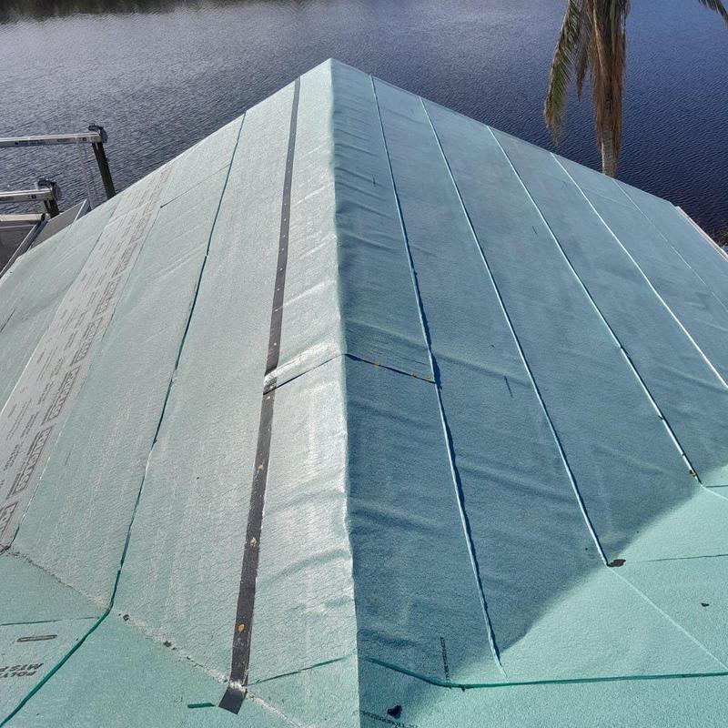 Roof underlayment installation on canalfront home