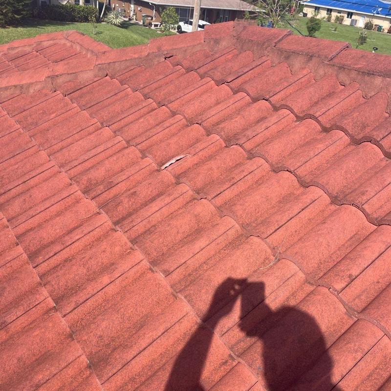 Concrete tile roof with minor broken tile visible